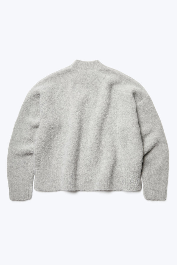 Flat lay of the back of the Hold Shearling Sweater Soft Grey. Made from an Alpaca blend and in a special shearling knit. This sweater has a flattering silhouette with cropped hem and dropped shoulder. 