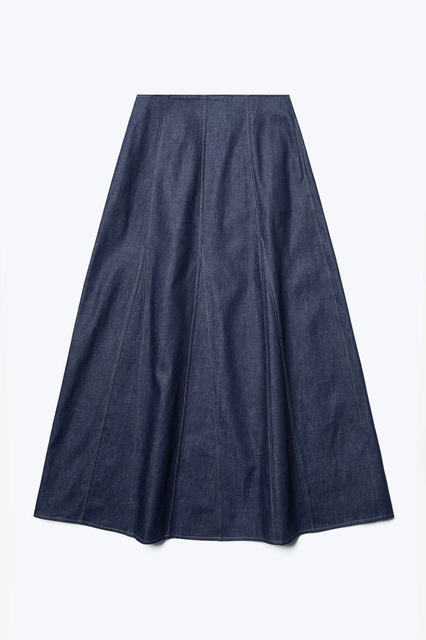 The front of the Idle Denim Skirt Indigo, a full godet style with contrast stitch details. This skirt features in seam side pockets.