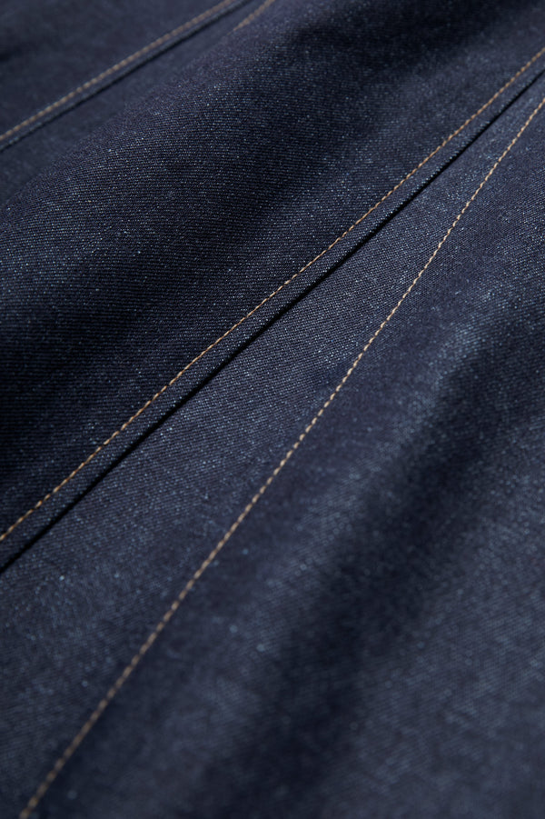 Close up of the Idle Denim Skirt Indigo crafted from Japanese denim and featuring contrast stitch details. 