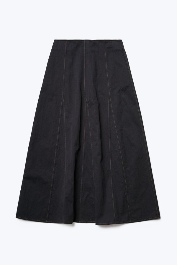 The front of the Idle Skirt Black, a full godet style with contrast stitch details. This skirt features in seam side pockets.