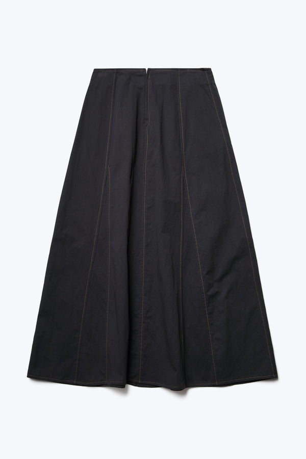 The back of the Idle Skirt Black, a full godet style skirt with contrast topstitch and a centre back zip closure. 