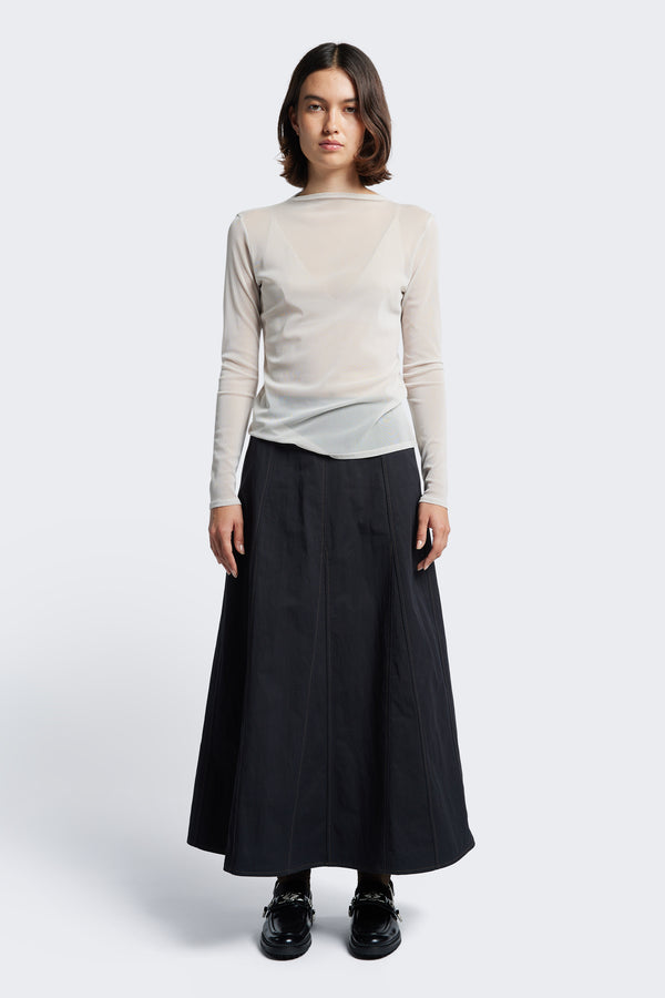 The Idle Skirt Black, a full godet style enhanced by contrast stitch details. The skirt features in seam side pockets and a centre back zip closure.