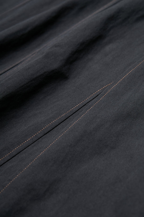 Close up of the brown contrast stitch details on the Idle Skirt Black.