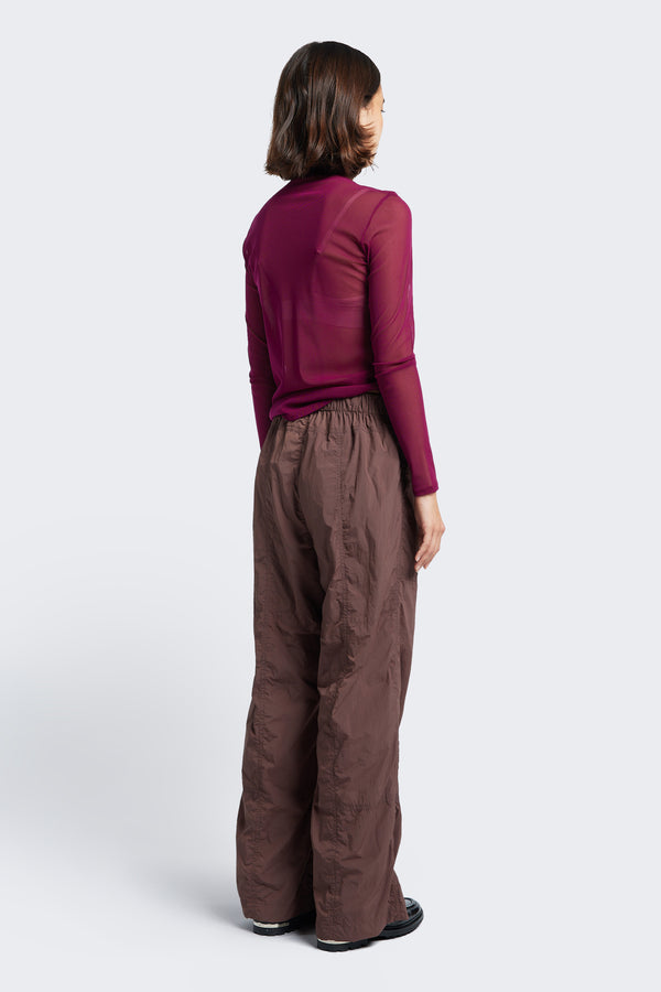 The back of the Inland Pant Cocoa, a loose fit, parachute style pant with a elasticated waistband and made from 100% Nylon. 