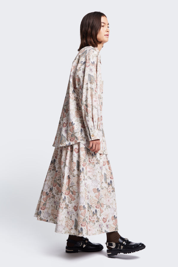 Side profile of the Interlude Skirt crafted in a fine wale cotton corduroy in Kloke's floral print with a raw hem.