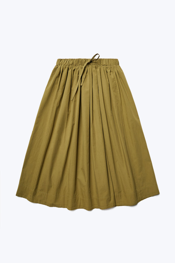 The front of Interlude Skirt Moss Green, a mid-length, full gathered skirt with an elasticated waistband and two front welt pockets. Made from 100% cotton. 