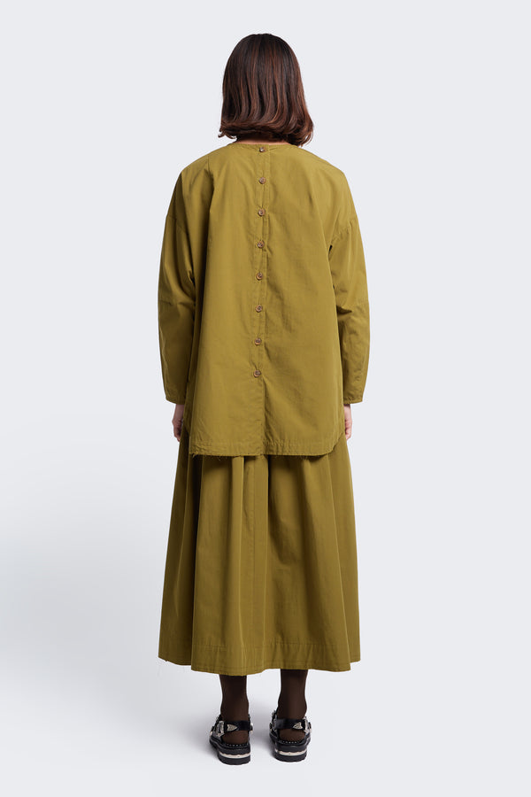 The back of the Interlude Skirt Moss Green, a mid length, full gathered skirt with an elasticated waistband and raw hem.