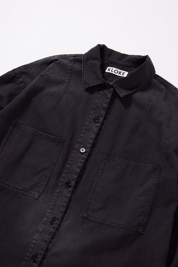 Close-up of the collar and front placket detailing on the Black Fade Iris Denim Shirt.