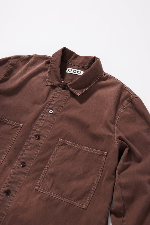 Close-up of the collar and front placket detailing on the Brown Fade Iris Denim Shirt.