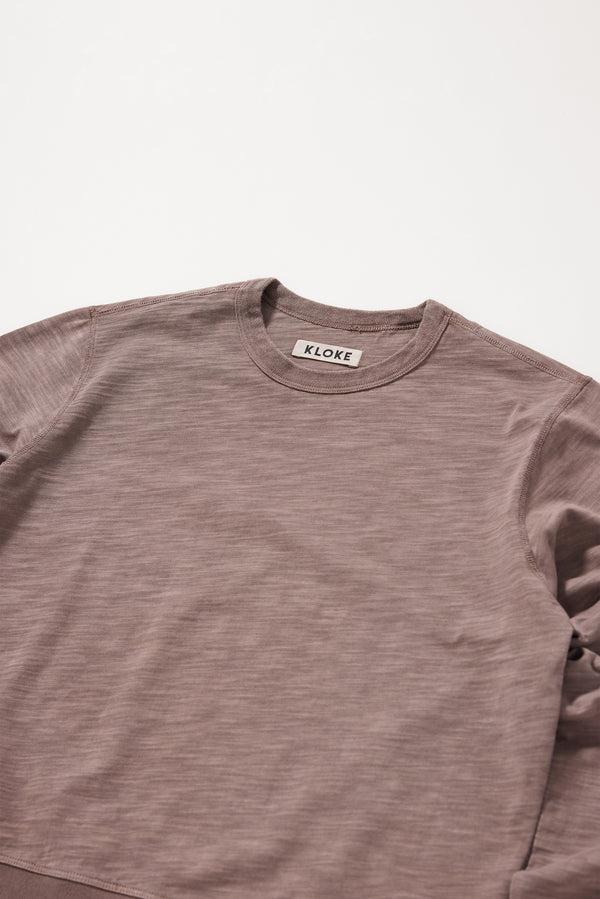 Close-up of the soft brown pigment-dyed cotton fabric showing its subtle texture and worn-in character.