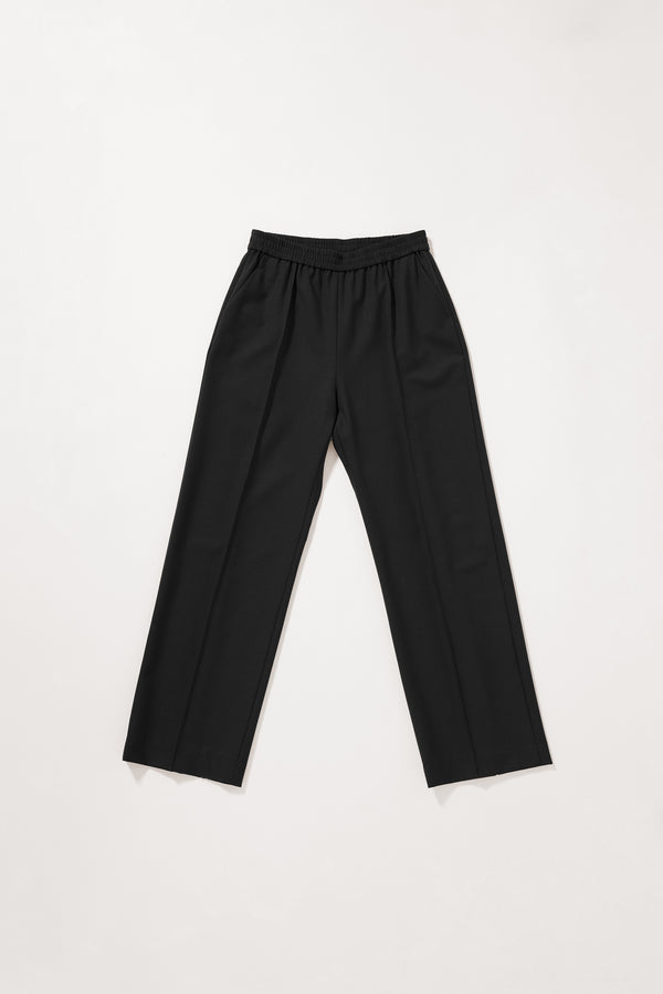 Flat front of the Black Manta Pant with a tailored silhouette, elasticated waistband and front pin tuck detailing.