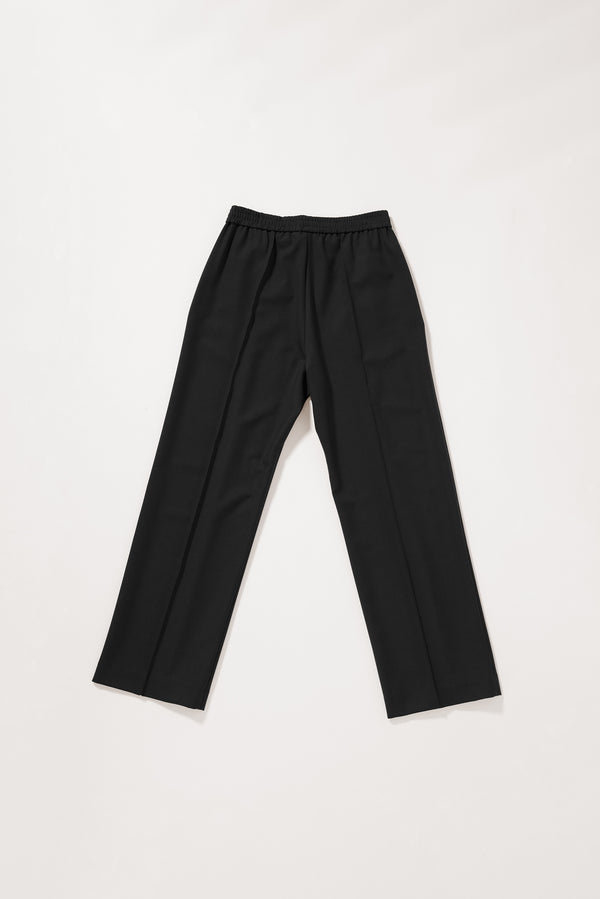 Flat Back view of the Black Manta Pant showing the clean tailored fit and elasticated waistband.