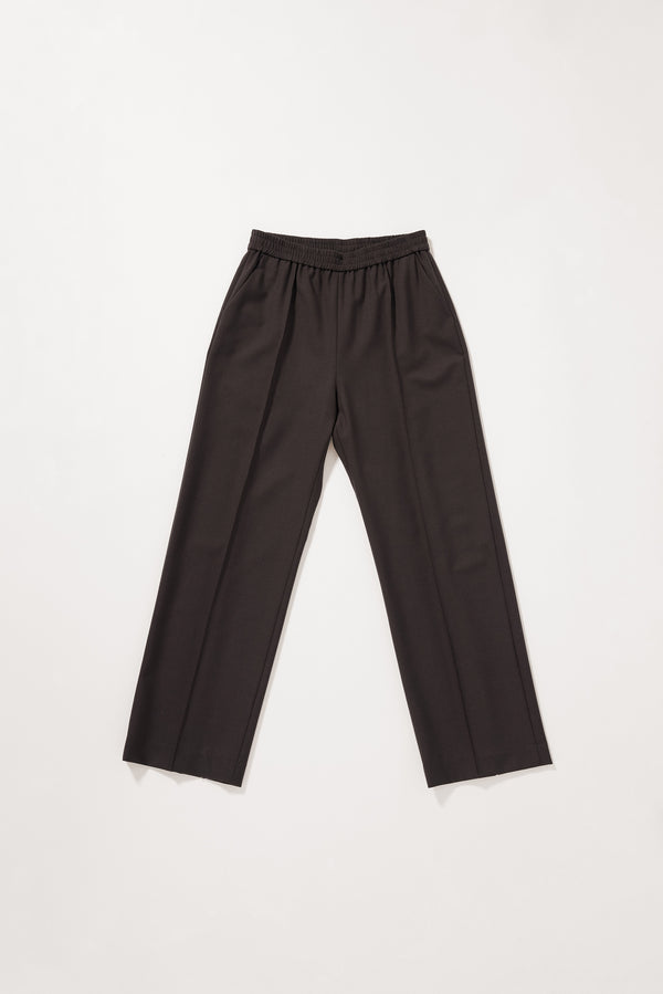 Flat front of the Dark Taupe Manta Pant with a tailored silhouette, elasticated waistband and front pin tuck detailing.