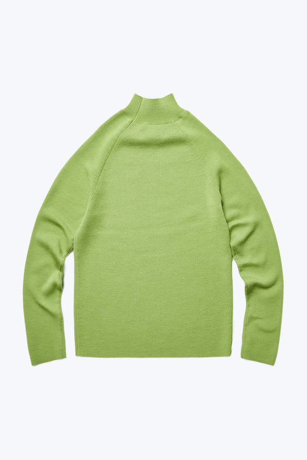 The front of Monument Mock Neck Sweater Apple Green. This slim fit sweater knitted in Merino Wool is an excellent layering option for the colder months.