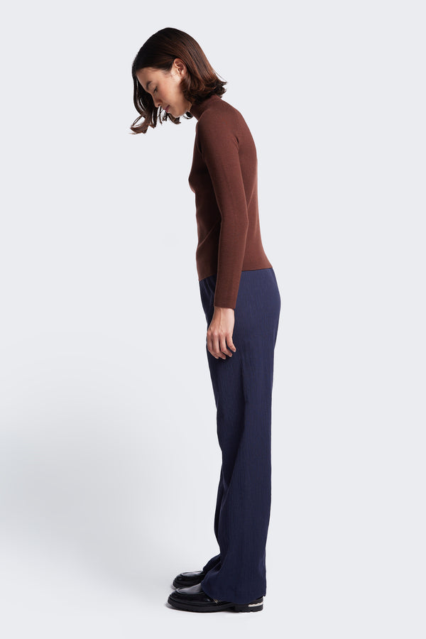 Side profile of the slim fit Monument Mock Neck Sweater in Brown, knitted from soft Merino Wool.