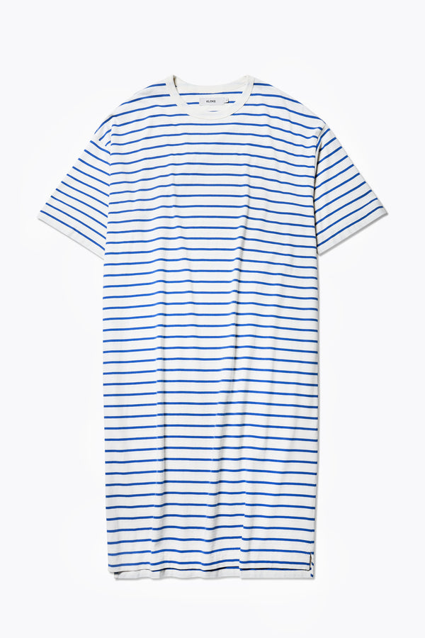 Flat lay of the Nadir Dress Blue Stripe, a summer style made from pure cotton jersey. Featuring side-splits, dropped shoulder, and up-sized elbow-grazing sleeves. 