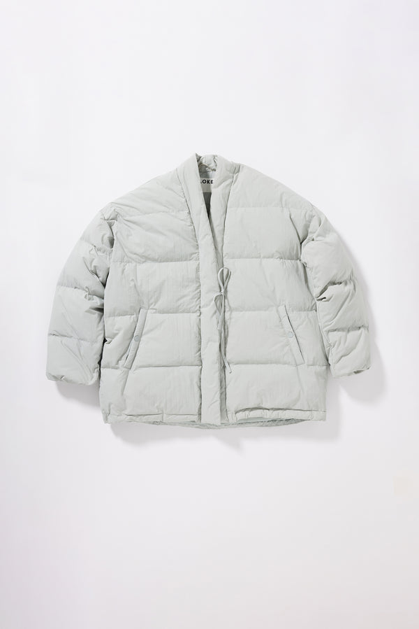 Flat front of the grey Nimbus Kimono Jacket worn closed with centre-front self-tie and zip, showing quilted recycled down construction and wrap silhouette