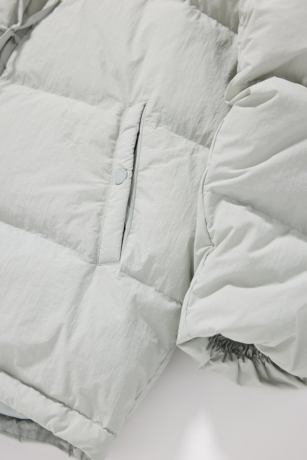 Close-up of quilted stitching on the grey Nimbus Kimono Jacket, filled with high-loft recycled post-consumer down