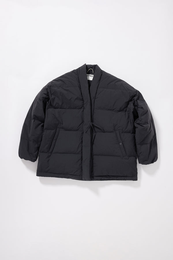 Flat front of the Vintage black Nimbus Kimono Jacket worn closed with centre-front self-tie, showing quilted recycled down construction and wrap silhouette