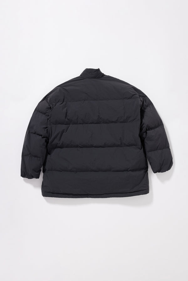 Flat back of the Vintage black Nimbus Kimono Jacket with centre-front self-tie, showing quilted recycled down construction and wrap silhouette