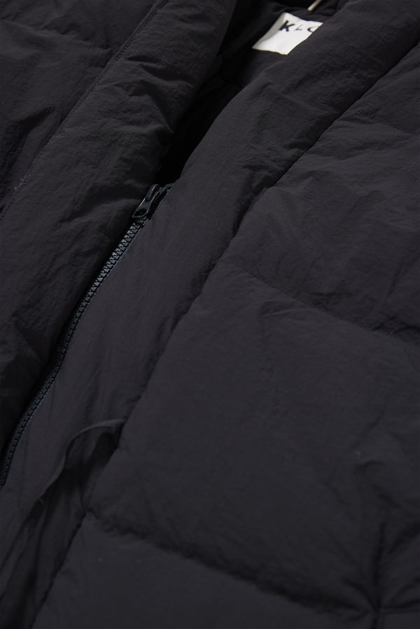 Close-up of quilted stitching and zip detail on the black Nimbus Kimono Jacket, filled with high-loft recycled post-consumer down