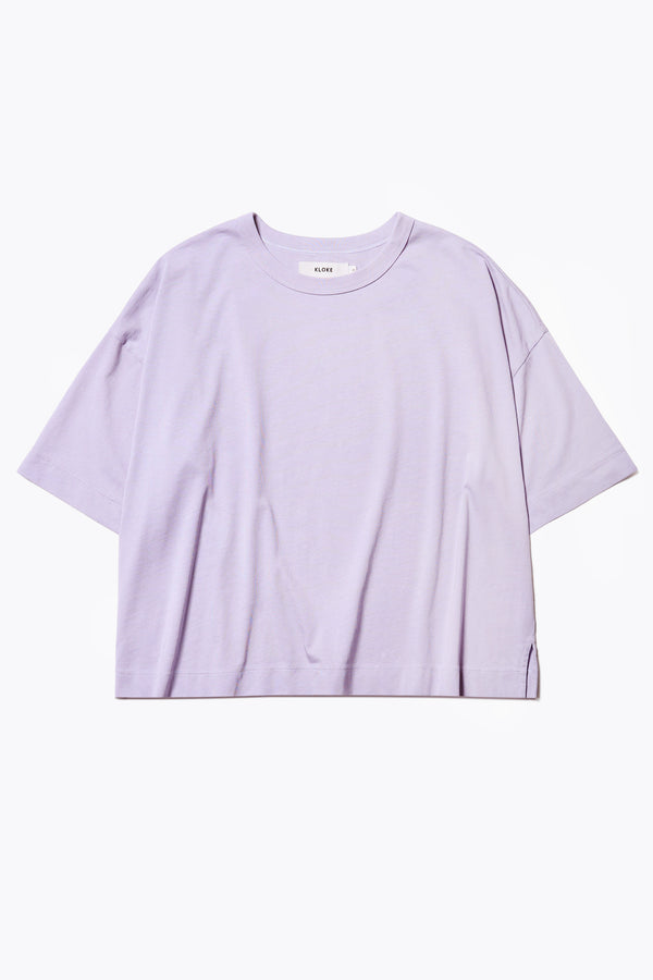 The Obelisk T-Shirt is a cropped oversize tee cut from high grad cotton in Lilac. The t-shirt has an extra thick 1 x 1 rib bound cover stitched neckline, straight hem, and side-slit detail.