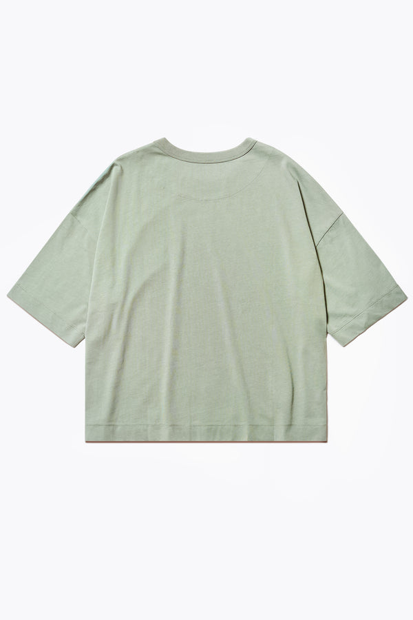 The back of the Obelisk T-Shirt Sage. Cut from high-grade cotton with an  extra thick 1 x 1 rib bound cover stitched neckline, straight hem, and side-slit detail.