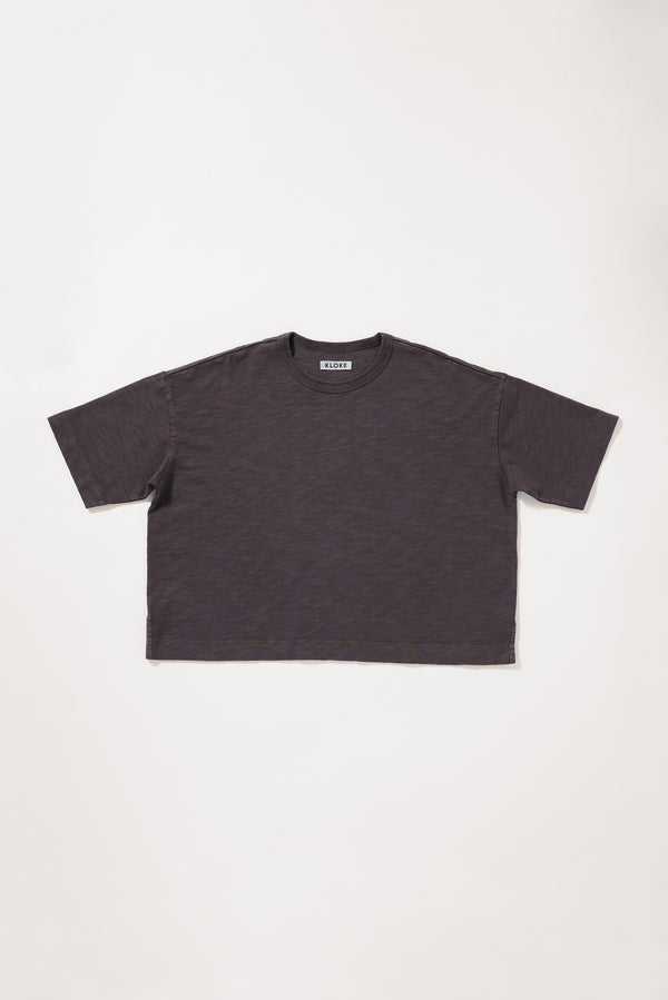 Flat front of the brown Obelisk Tee in pigment-dyed cotton with a relaxed boxy fit and oversized elbow-grazing sleeves.