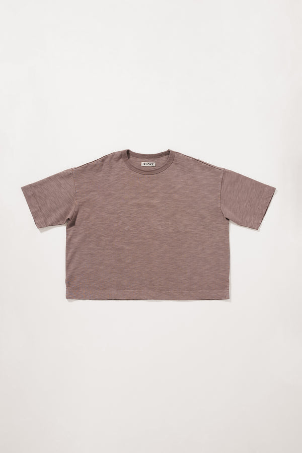 Flat front of the brown Obelisk Tee in pigment-dyed cotton with a relaxed boxy fit and oversized elbow-grazing sleeves.