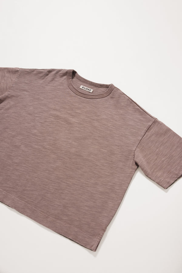 Close-up of the soft pigment-dyed cotton fabric showing its subtle texture.