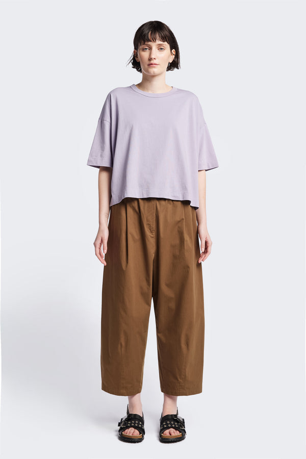 Model wears a cropped oversize t-shirt in Lilac Purple. The Obelisk T-Shirt is cut from a soft, durable high-grade cotton. This t-shirt is a wardrobe staple.