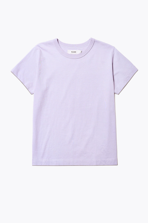 Front of the Oceania Tee, a classic t-shirt cut from organic cotton jersey in Lilac. Features a 1 x 1 rib bound cover stitched neckline. Available in 5 sizes.