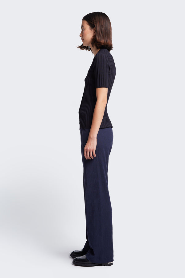 Side profile of the Oracle Crinkle Pant, a straight leg pant with an elasticated waistband. Made from a special crinkle fabrication in Ink. 