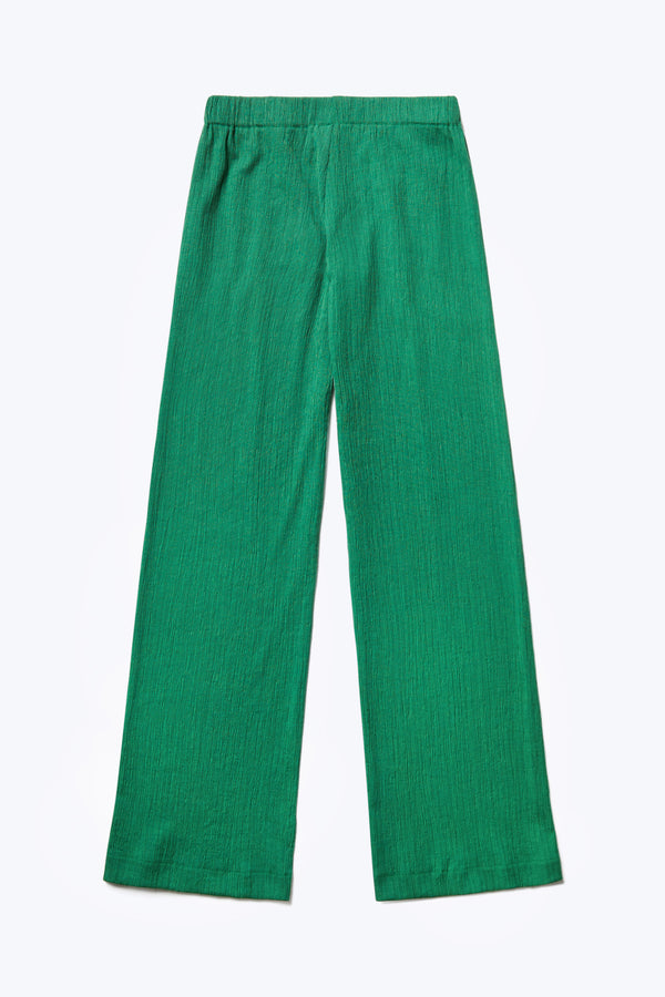 Flat lay of the Oracle Crinkle Pant, a slim fit pant with an elasticated waistband. Made from a special crinkle fabrication in Green. 