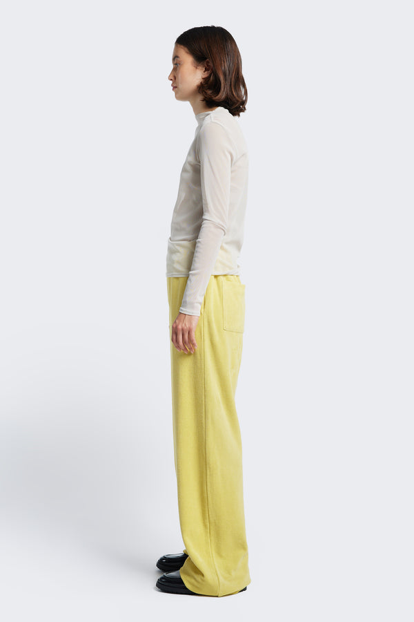 Side profile of the Prone Towelling Track Pant Butter, a straight leg, slouchy track pant crafted from Okeo-tex standard cotton terry.