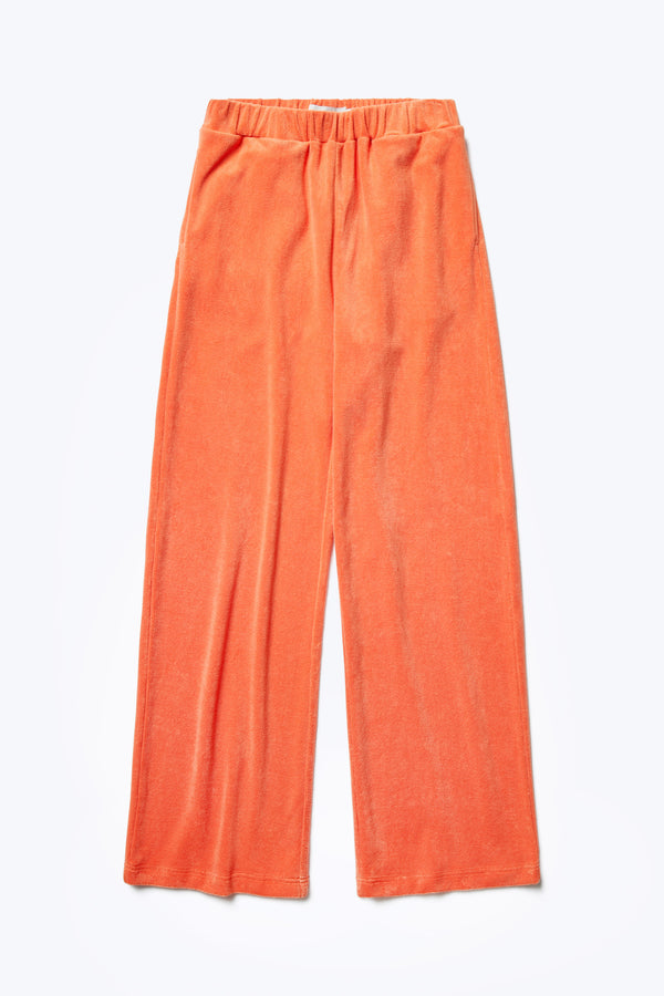 The front of the Prone Towelling Track Pant, a slouchy track pant with an elasticated waist band. Crafted from an  Okeo-tex standard cotton terry in Tangerine Orange.