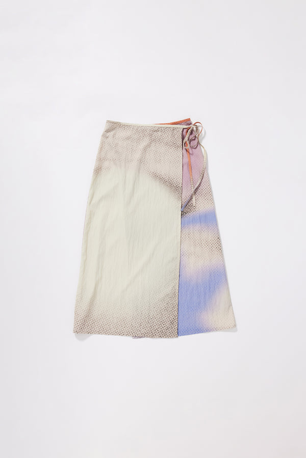 Purview Skirt in Aion Print front view showing wrap A-line midi silhouette with fragmented asymmetric deity print in distorted mauve, blue and orange