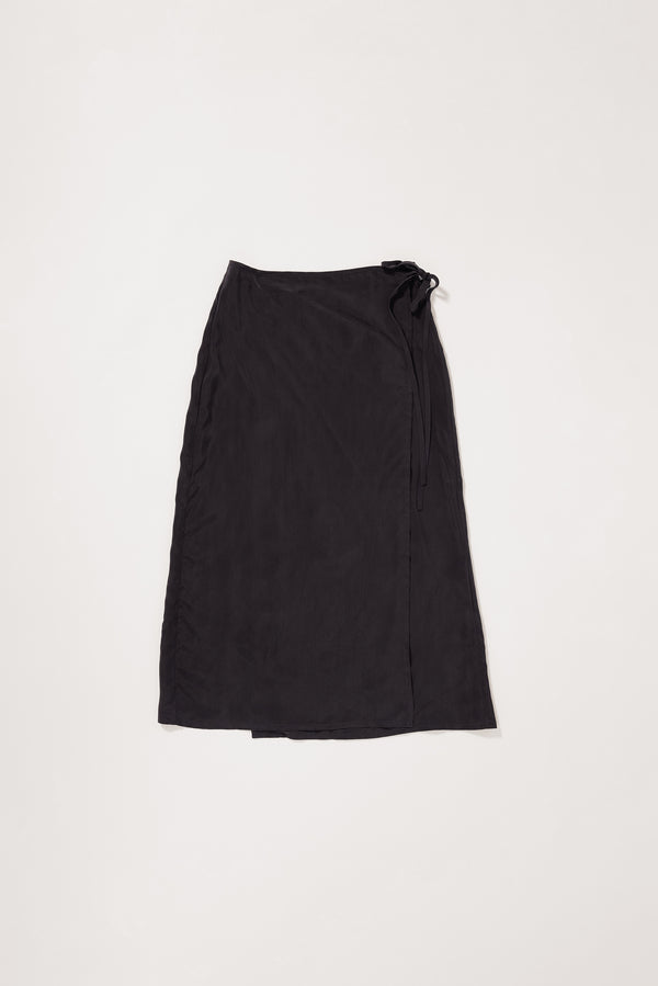 Flat Front of the Purview Skirt in Vintage Black Cupro showing wrap A-line midi silhouette. 