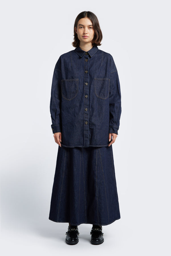 The Recess Denim Shirt is a relaxed button up shirt. Featuring two front patch pockets at the chest, scoop hem and stand collar. Crafted from Japanese denim is Indigo. 