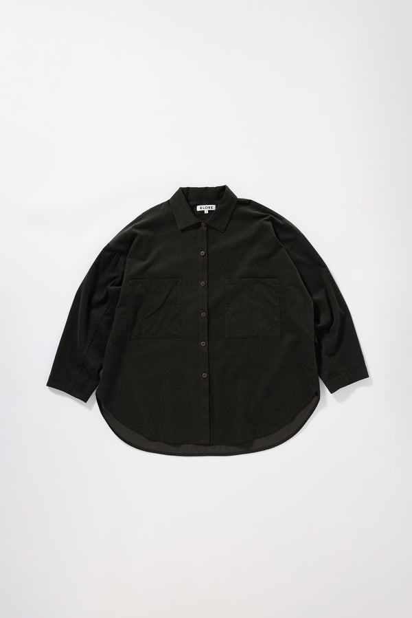 Flat front of the Refraction Cord Shirt in Brown showing edge-stitched stand collar, dropped sleeves, front patch pockets and double over-dyed cotton corduroy


