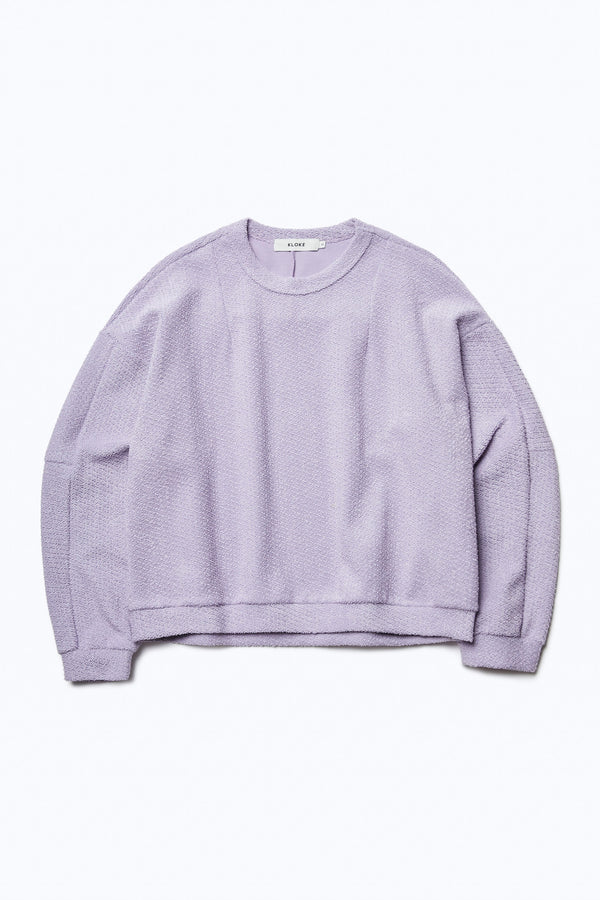 The front of the Respite Sweater Lilac Purple, a cropped style jumper in loop front jersey. Features panelled sleeves, front darts at the collar and back straight dart detail. 