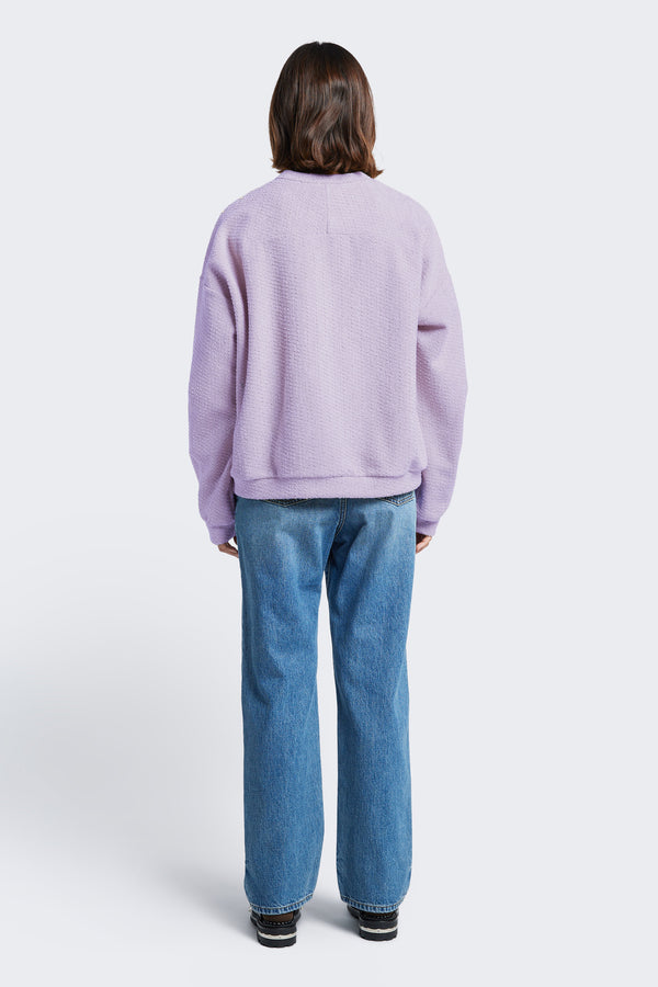 The back of the Respite Sweater Lilac, a cropped jumper with a relaxed silhouette and back straight dart detail. 