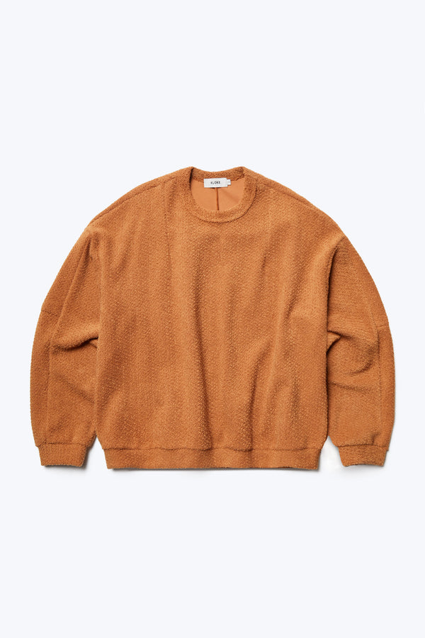 The front of the Respite Sweater Rusty Brown, a cropped style jumper in loop front jersey. Features panelled sleeves, front darts at the collar and back straight dart detail. 