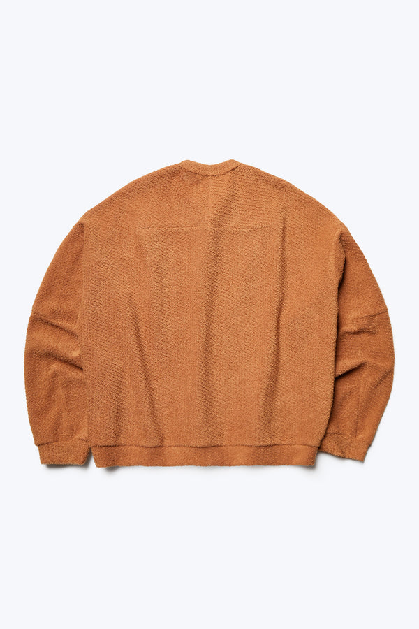 The back of the Respite Sweater, a cropped style jumper in a loop front jersey in Rusty Brown. Features back straight dart detail.