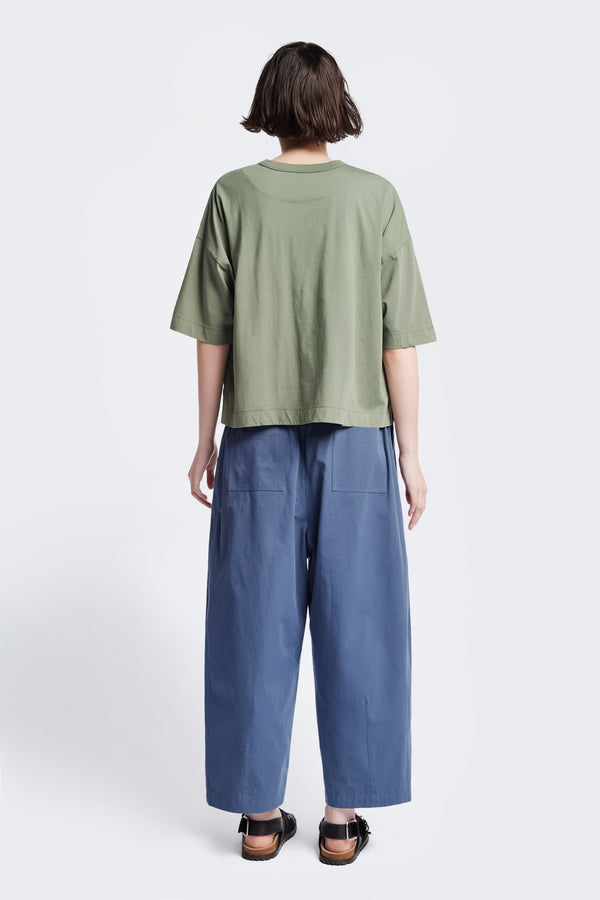 The back of the Obelisk T-Shirt Sage Green, a cropped oversize tee cut from soft, high grade cotton. This tee has an  extra thick 1 x 1 rib bound cover stitched neckline and straight hem.