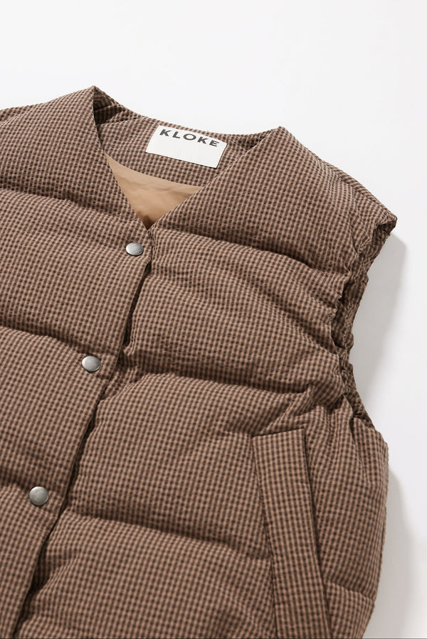 Close up of the quilted down construction and fabric texture on he brown Static Vest
