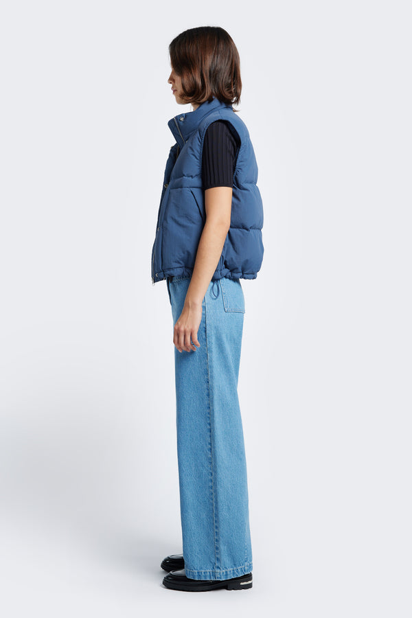 The side profile of the Stay Quilted Puffer Vest Blue with elasticated armholes for comfort and elastic waist pulls with toggles to adjust the shape. 