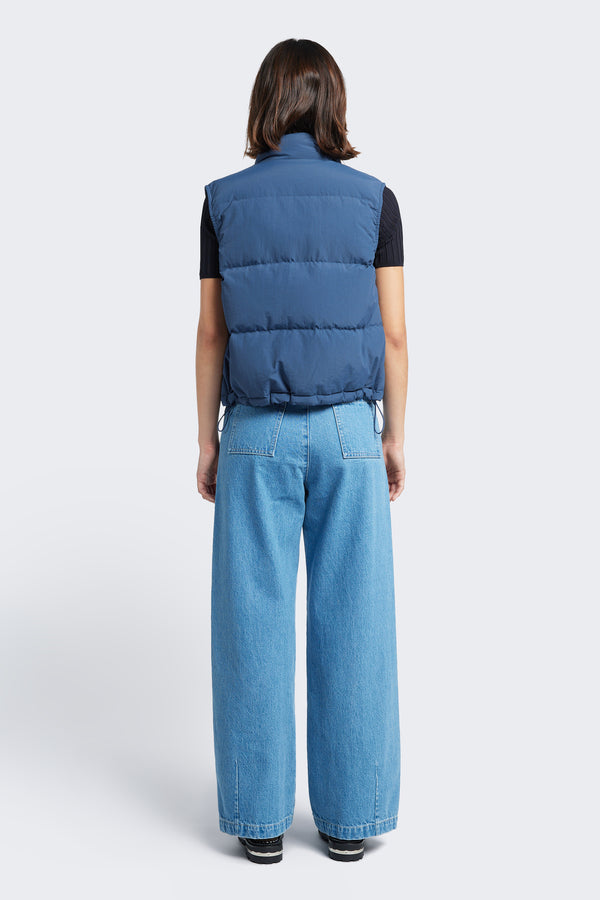 The back of the Stay Quilted Vest Blue is a quilted down puffer vest. Features elastic waist pulls with toggles to adjust the shape. 