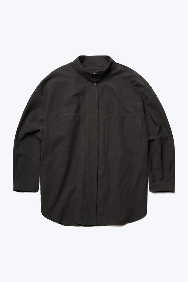 The Tenet Blouson Shirt is a relaxed silhouette, long sleeve shirt with centre concealed button placket, two front patch pockets at the chest and high stand collar with button closure. Made from a textural cotton fabric in Black. 