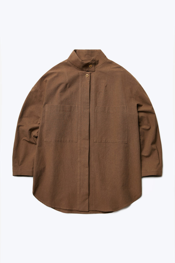 The Tenet Blouson Shirt is a relaxed silhouette, long sleeve shirt with centre concealed button placket, two front patch pockets at the chest and high stand collar with button closure. Made from a textural cotton fabric in Brown.